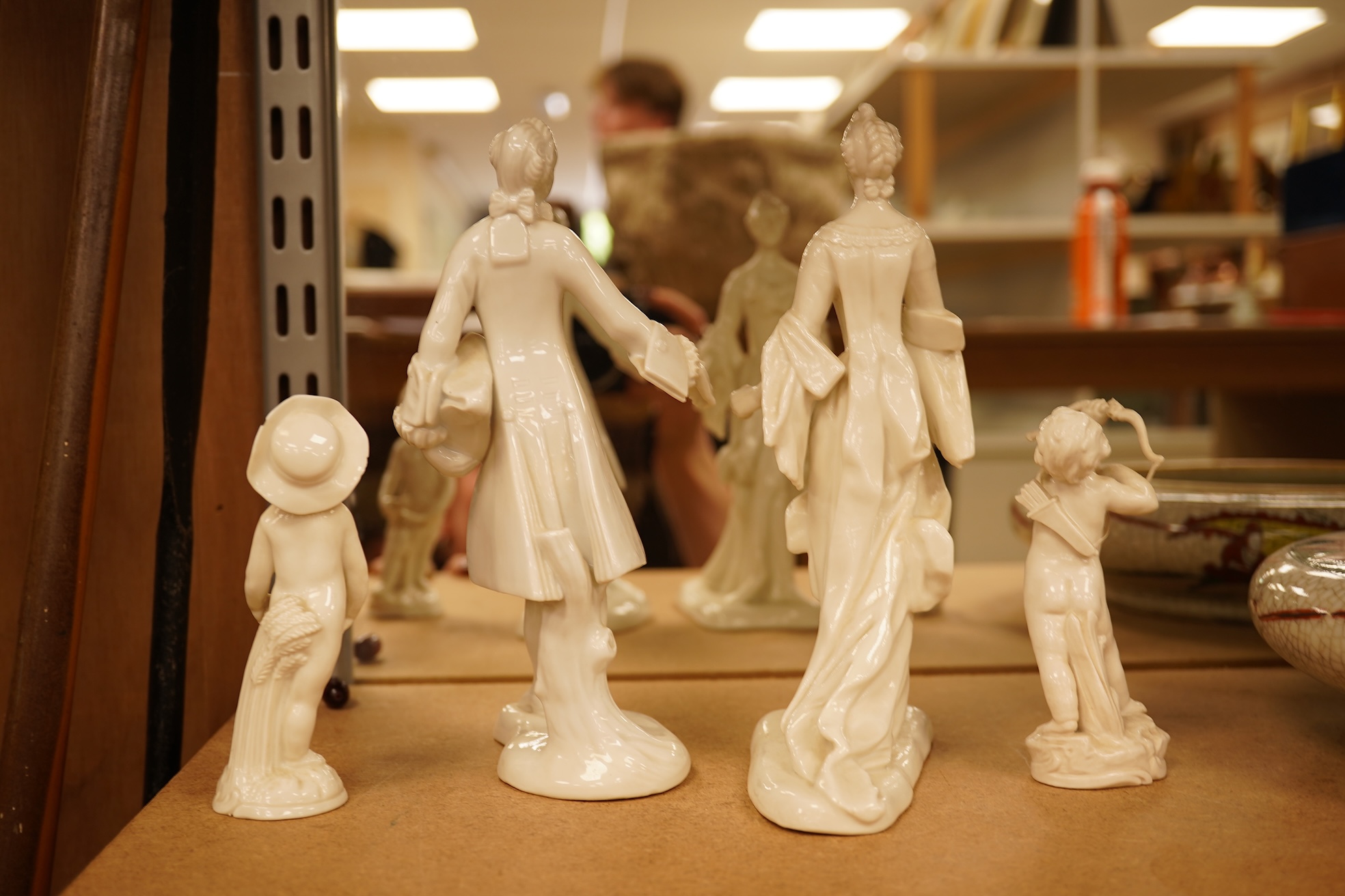 Two Nymphenberg white glazed figures, after Bustelli and two similar cherubs (4) figure 19 cm high